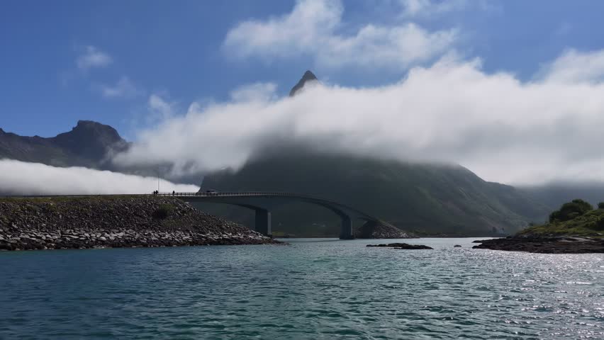 Fredvang bridges with clouds passing over mountain peak in lofoten islands, norway