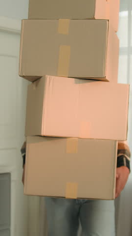 Clumsy African American man carry heavy parcels drop boxes irritated frustrated angry fatigue with relocation moving in new home male guy renting flat receiving shopping delivery packages falling
