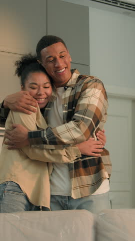 African American couple pushing new furniture couch sofa hugging smiling enjoying delivery service ethnic family woman man moving day happy in own home loan mortgage credit buying online shopping