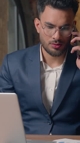Stressed mad furious Arabian businessman arguing smartphone call business man screaming talking aggressive mobile phone in office angry Indian guy male Hindu executive annoyed job quarrel conversation