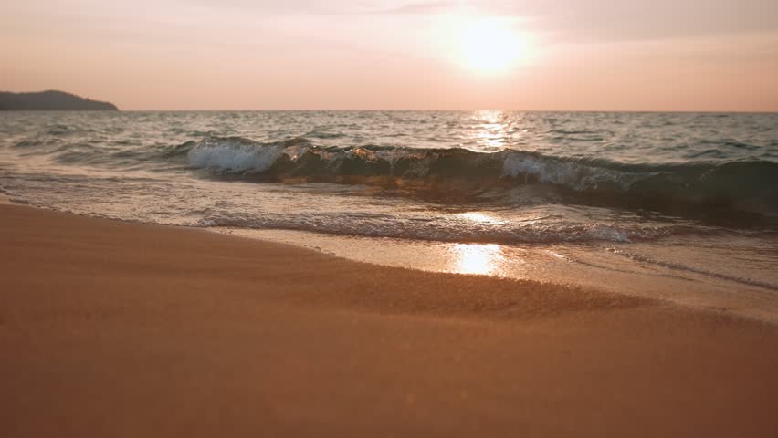 Waves gently washing shoreline with golden sunset, tropical tranquility in scenic Thailand landscape