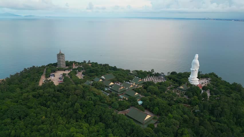 religious Lady Buddha monument at Linh Ung pagoda and buddhism temple, Asian religion and spirituality, Son Tra peninsula, Da Nang, Vietnam 4k aerial drone view