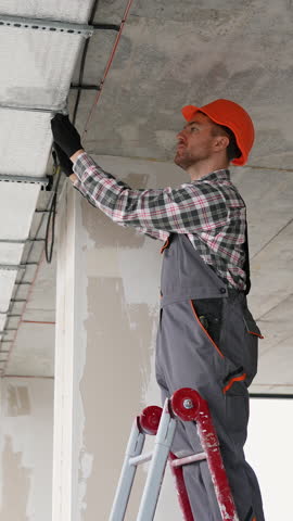 Ventilation expert installing ceiling system in office