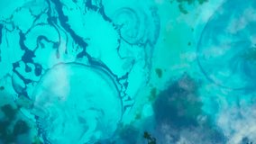 Turquoise water surface showing concentric ripples and algae bloom. Media - Powered by Shutterstock - Get 15% off with code: PIKWIZARD15