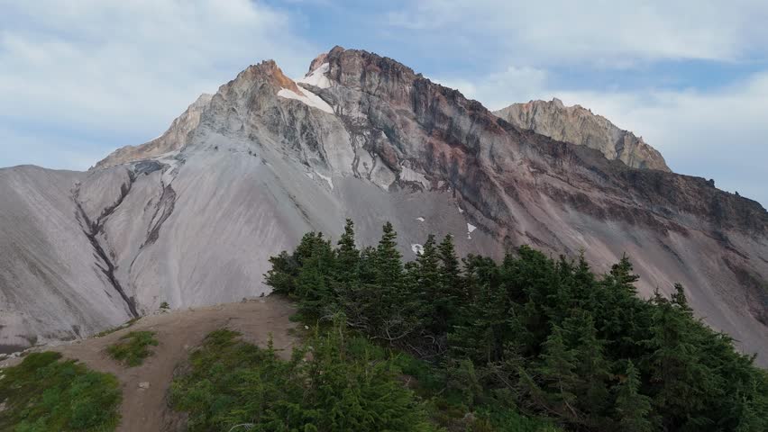 Majestic Mountain Peaks and Evergreen Forest in the Rugged Wilderness of British Columbia, Canada