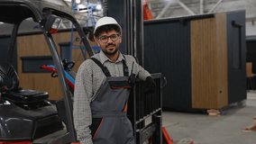 Smiling storage worker giving thumbs up near forklift in warehouse - Powered by Shutterstock - Get 15% off with code: PIKWIZARD15