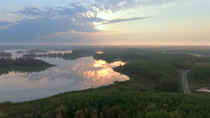Aerial sunrise over forested lakes in Elk Island National Park, Alberta