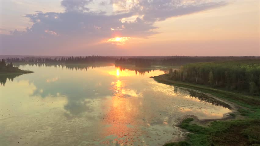 Aerial sunrise over forested lakes in Elk Island National Park, Alberta