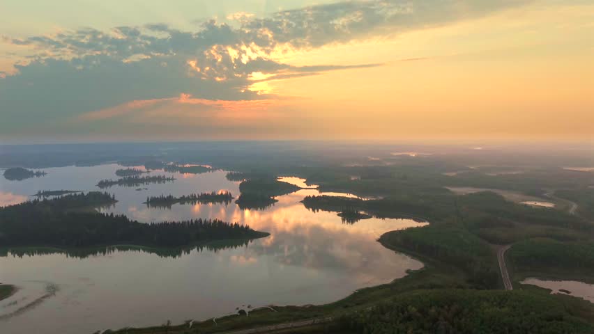 Aerial sunrise over forested lakes in Elk Island National Park, Alberta