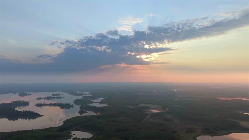 Aerial sunrise over forested lakes in Elk Island National Park, Alberta