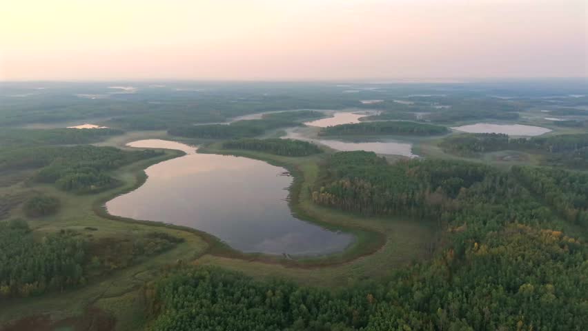 Aerial sunrise over forested lakes in Elk Island National Park, Alberta