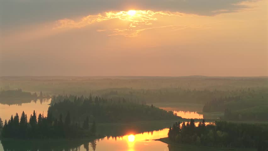 Aerial sunrise over forested lakes in Elk Island National Park, Alberta