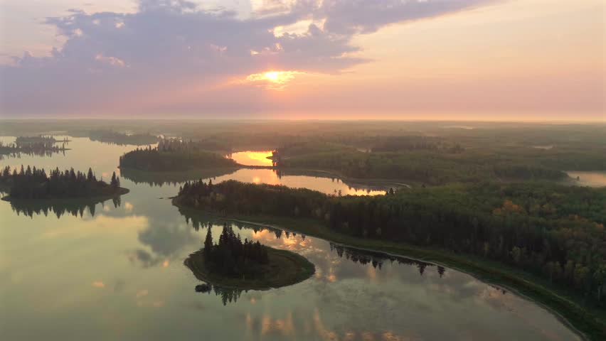 Aerial sunrise over forested lakes in Elk Island National Park, Alberta