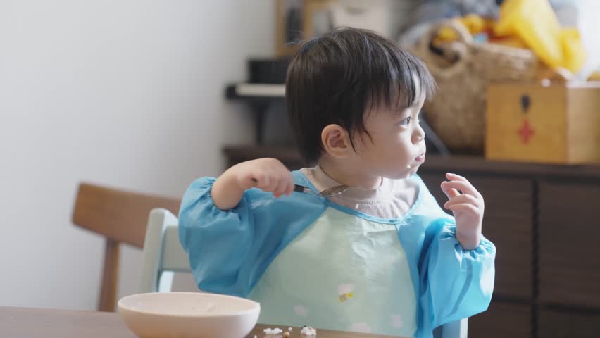 A boy who is almost 2 years old and enjoys eating