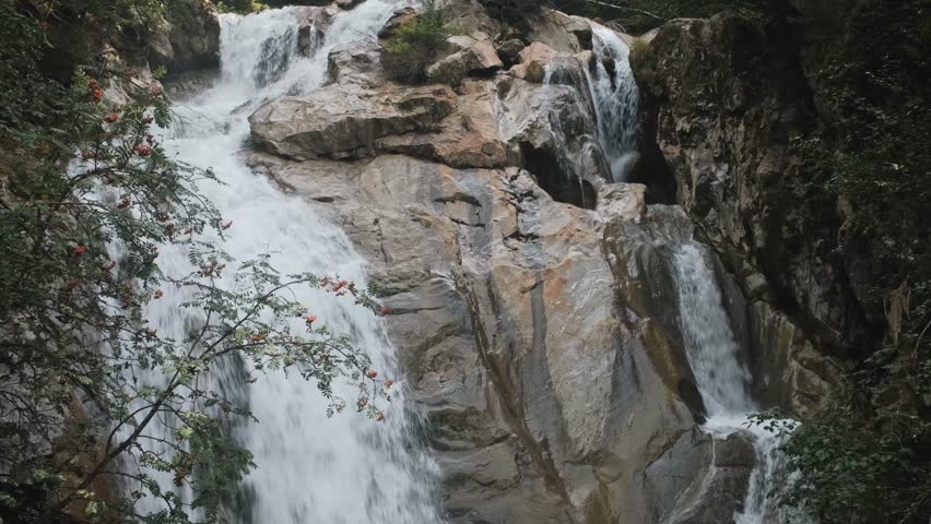 Wild glacier stream flows through rocky gorge near the Stubai Glacier in Tyrol, Austrian Alps.