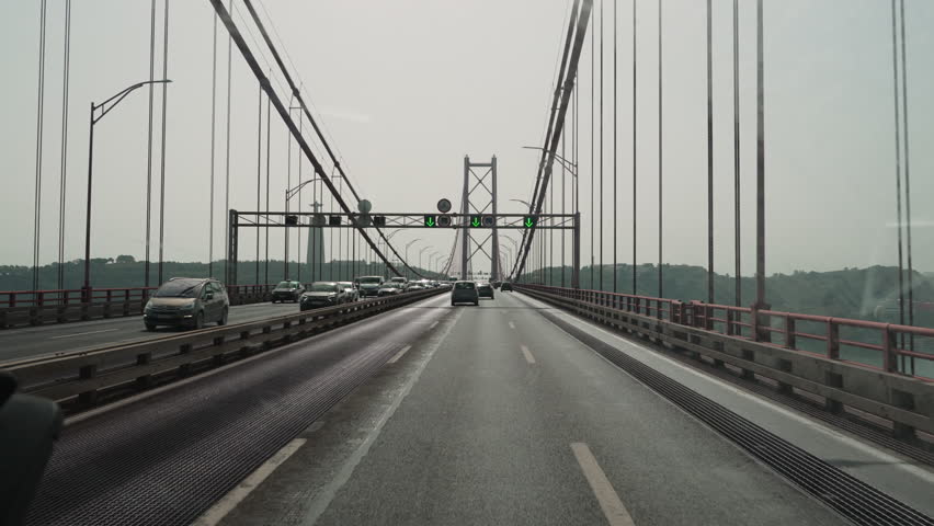 traffic on a highway crossing the april 25th bridge in Lisbon across the Tagus river.