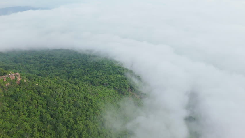 Aerial view of misty mountains and dense forests in Thailand, showcasing natural landscapes, environmental conservation, and sustainable nature.