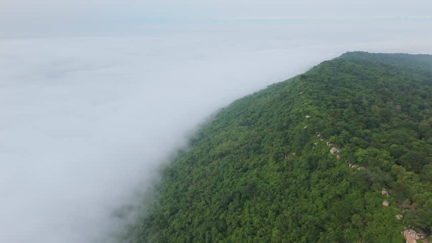 Aerial view of misty mountains and dense forests in Thailand, showcasing natural landscapes, environmental conservation, and sustainable nature.