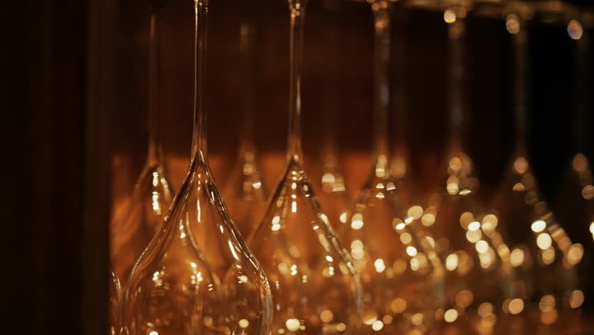 Close up of empty glasses turned upside down on a shelf
