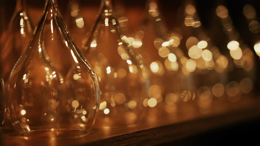 Close up of empty glasses turned upside down on a shelf