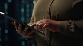 Close up shot of admin working in data center using tablet to optimize network mainframes. IT employee in server farm diagnosing and resolving hardware glitches using device - Powered by Shutterstock - Get 15% off with code: PIKWIZARD15