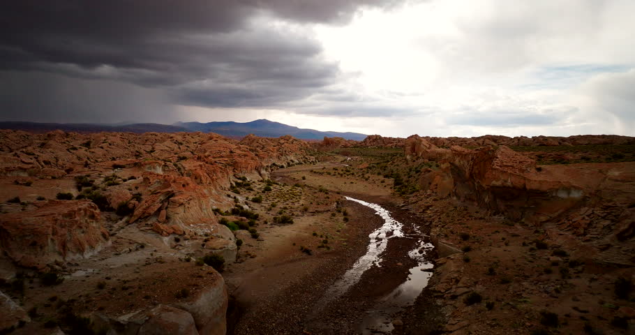 River snakes through valley of Siloli high-mountain desert in Bolivia, aerial
