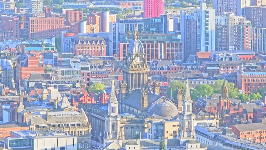 Aerial view of Leeds Town Hall, UK. Illuminated in soft golden evening light, historic Victorian architecture, a landmark symbol of the city’s cultural and civic heritage.
