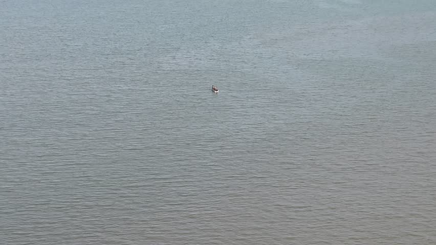 A small fishing boat in the middle of the sea