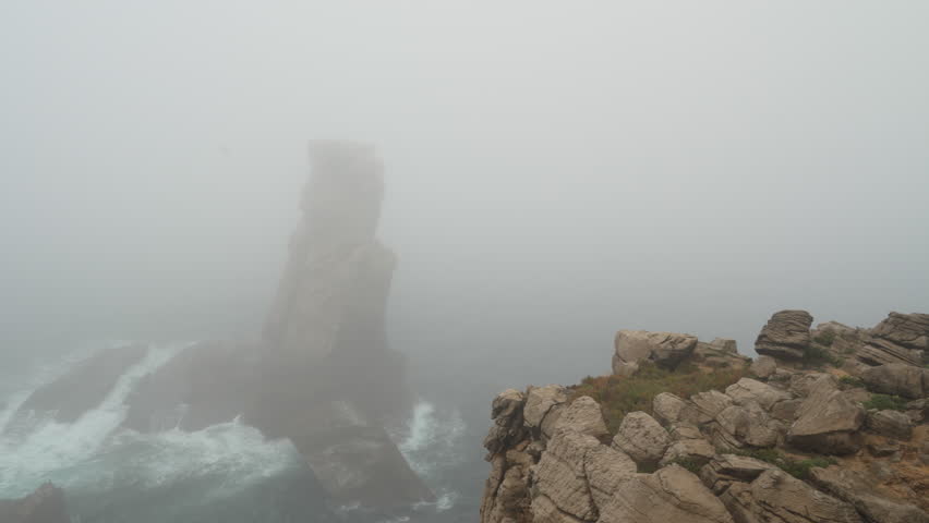 rugged rock formation of Peniche peninsula with high cliffs near Varanda de Pilatos in Portugal during dusk.