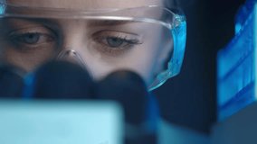Female virologist scientist using microscope in laboratory. Biochemical and medical research. Pharmacist specialist working with lab equipment analyzing samples and searching for vaccine development - Powered by Shutterstock - Get 15% off with code: PIKWIZARD15