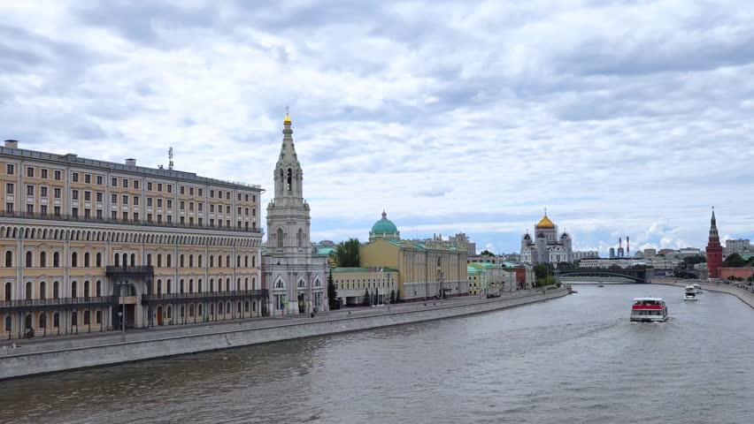 Panoramic view of Moscow city center and Moskva river with tour boat. The Red Square, Kremlin towers on background. Urban life travel. 
