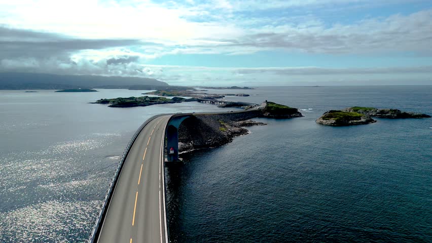 Cruising along the breathtaking Atlantic Ocean Road in Norway reveals stunning coastal landscapes. The serene waters shimmer as small islands dot the horizon, inviting exploration and adventure.