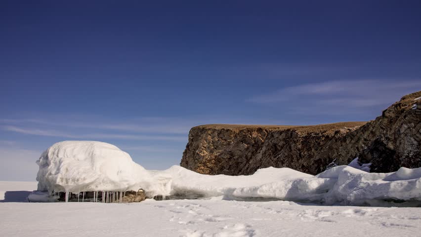 Time lapse rock mountain in the snow winter, sky clouds moving in the nature background