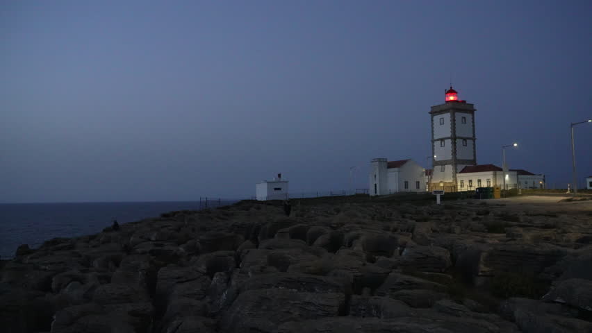rugged rock formation of Peniche peninsula with high cliffs near Varanda de Pilatos in Portugal during dusk.