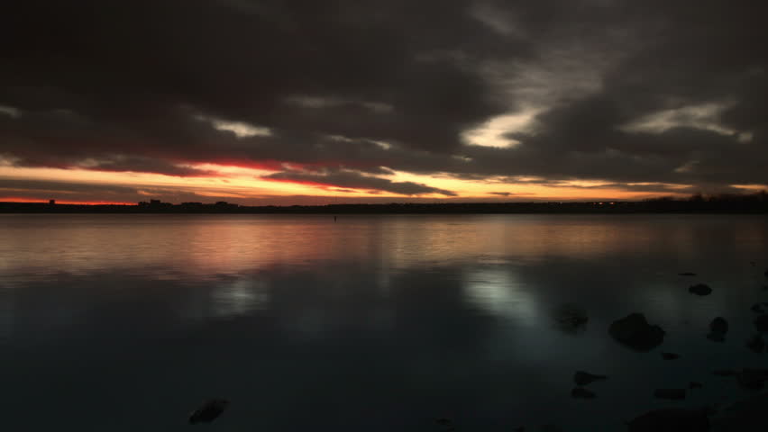 Red sunrise over a lake in Colorado. Beautiful water motion. HD 1080p time