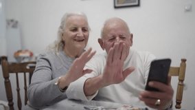 Old man and a woman couple are sitting on a bed giving a kiss and love gestures with hands toward the camera, slow motion - Powered by Shutterstock - Get 15% off with code: PIKWIZARD15