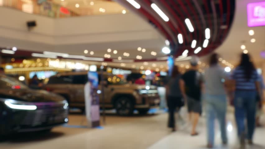Time Lapse Blurred Car Exhibition in Shopping Mall - Defocused Auto Show Display with Bokeh Effect in Modern Showroom