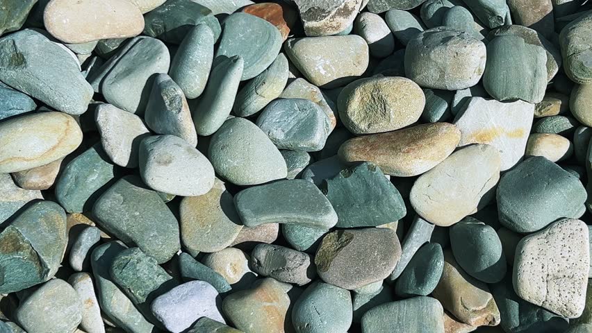 River pebble paving in the garden. This is a universal and durable solution for landscape design, for creating paths, flower beds, alpine slides, rockeries, and also as a drainage and mulching layer.