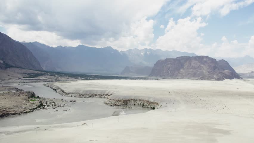 Indus River cutting through Skardu’s Cold Desert with Karakoram backdrop. Skardu, Pakistan