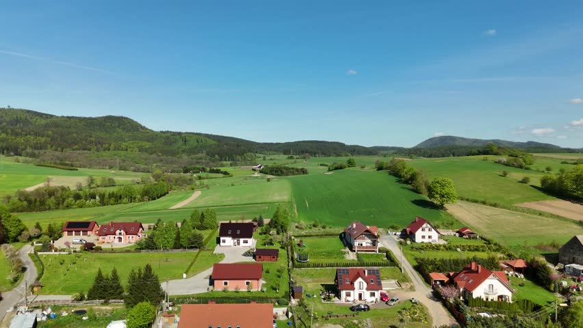 Aerial View of a Picturesque Countryside Village in Poland Surrounded by Green Fields and Forests