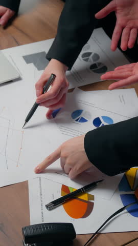 Three talking concentrated business women team girls multiracial female businesswomen Asian Caucasian Muslim managers planning marketing strategy documents economy sales satisfied result in office