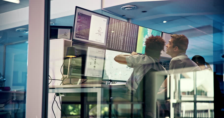 People, computer and screen with satellite in control room, monitor weather and climate change. Staff, discussion and online report for forecast update, study storm pattern and disaster surveillance