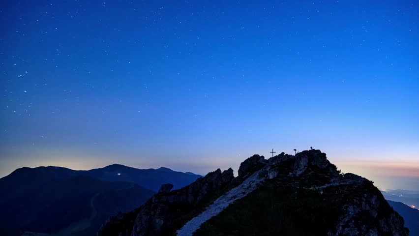 Timelapse of Starry Night Sky with Star Above Mountain Peak with Cross in bueatiful Landscape