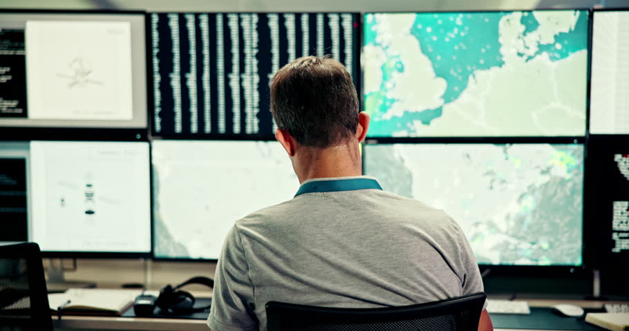 Man, computer and screen with satellite in control room, monitor weather and climate change. Back, meteorologist and online alert of hurricane update, study storm pattern and surveillance of disaster