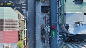 Top-down aerial view showing the contrast of a modern building and old houses divided by a subway construction trench. - Powered by Shutterstock - Get 15% off with code: PIKWIZARD15