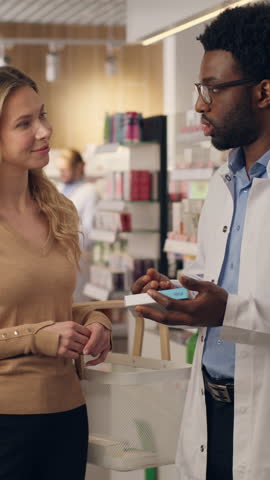 Pharmacist doctor help customer medicine recommendation advice buying pills vitamins in pharmacy health care products African American man Caucasian woman buy medication drugstore medical consultation