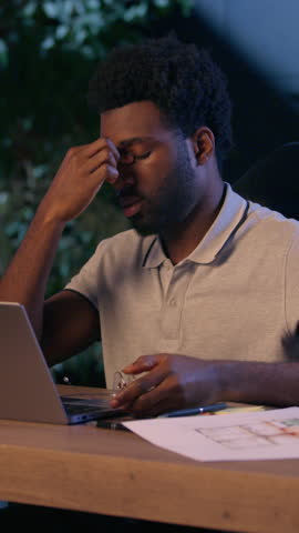 African American architect business man laptop work overtime in night office tired businessman overwork exhausted male guy discomfort evening take off glasses suffer eyesight head ache dry eyes health
