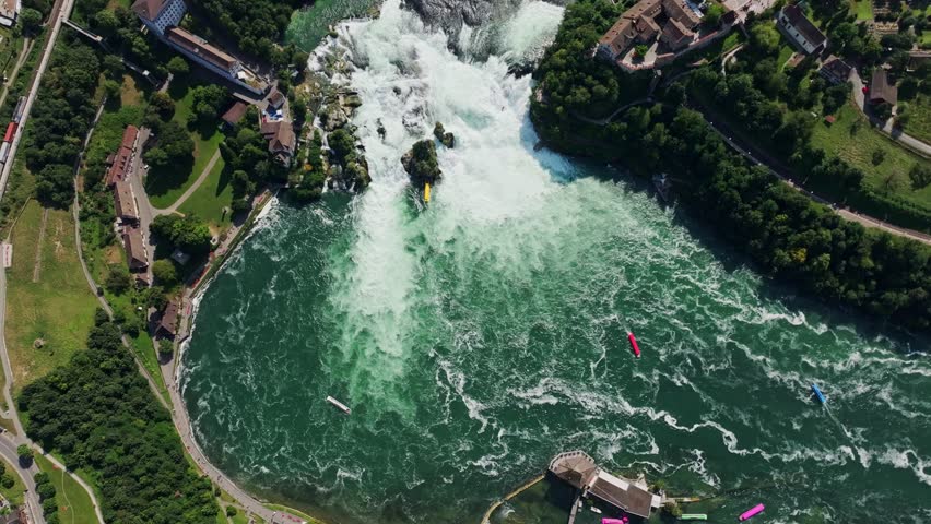 Top down drone of Rhine Falls Switzerland among cliffs and lush green hills