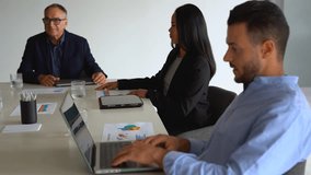 Multi generational business people working together inside modern office sharing ideas - Multiracial colleagues and entrepreneur concept - Focus on young man using laptop - Powered by Shutterstock - Get 15% off with code: PIKWIZARD15
