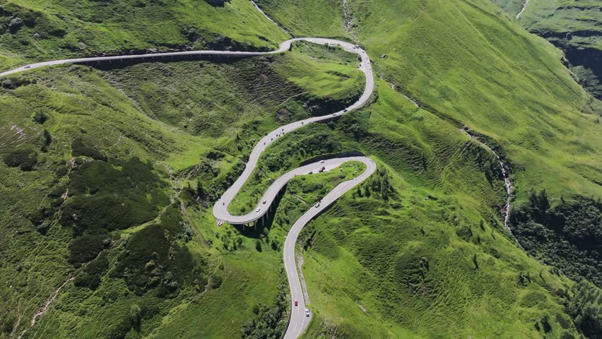 Drone of iconic Grossglockner High Alpine Road winding through green slopes